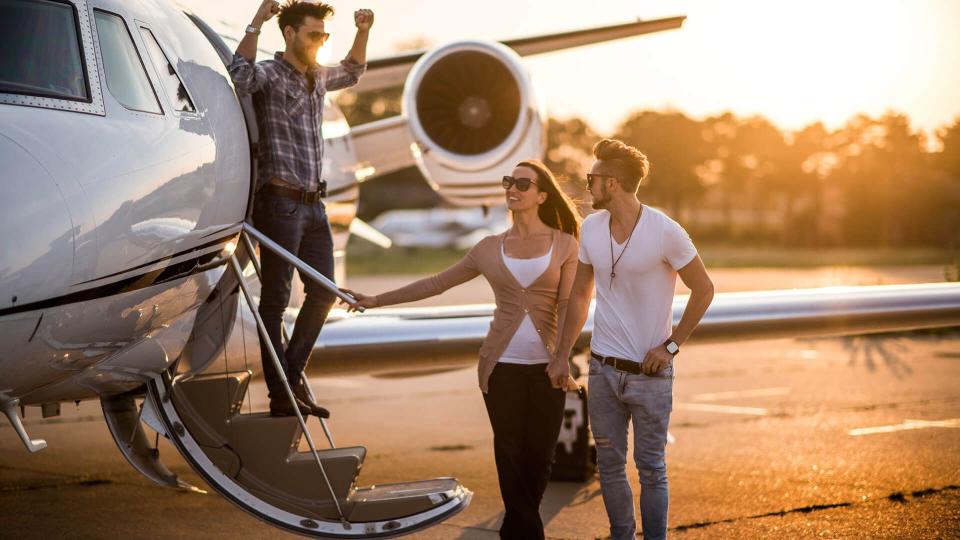 friends getting off airplane