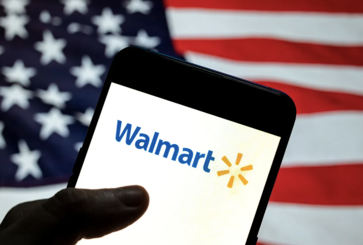 Walmart 4th of July sales. Walmart logo on phone in front of a flag