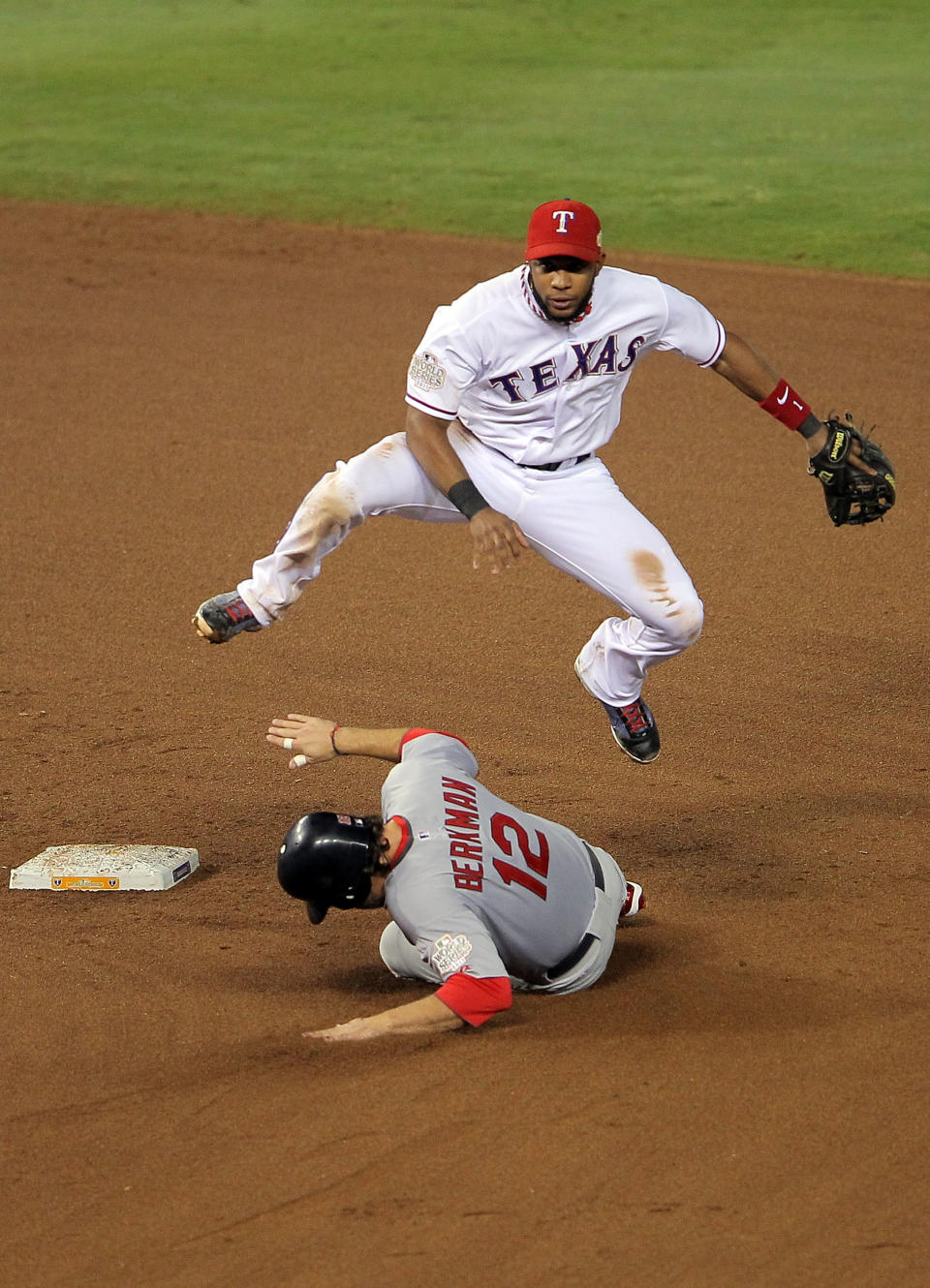 ARLINGTON, TX - OCTOBER 23: Elvis Andrus #1 of the Texas Rangers turns the double play as Lance Berkman #12 of the St. Louis Cardinals slides into second base in the fifth inning during Game Four of the MLB World Series at Rangers Ballpark in Arlington on October 23, 2011 in Arlington, Texas. (Photo by Doug Pensinger/Getty Images)