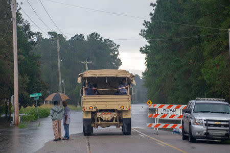 South Carolina National Guard motor transport operators from Bennettsville, S.C., assist local residents evacuating from rising flood waters as a result of Hurricane Florence in Bucksport, South Carolina, U.S. September 24, 2018. Picture taken September 24, 2018. Staff Sgt. Jorge Intriago/U.S. Army National Guard/Handout via REUTERS