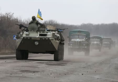 Members of the Ukrainian armed forces ride on an armoured personnel carrier near Artemivsk, eastern Ukraine, March 3, 2015. REUTERS/Gleb Garanich