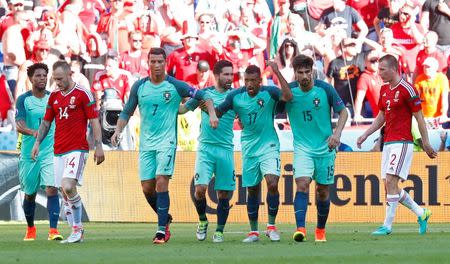 Football Soccer - Hungary v Portugal - EURO 2016 - Group F - Stade de Lyon, Lyon, France - 22/6/16 Portugal's Nani celebrates with Cristiano Ronaldo and Andre Gomes after scoring their first goal REUTERS/Kai Pfaffenbach Livepic