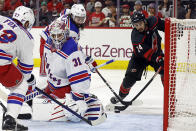 Carolina Hurricanes' Seth Jarvis (24) slips past New York Rangers' Mika Zibanejad (93) to shoot the puck past goaltender Igor Shesterkin (31) for a goal during the second period in Game 6 of an NHL hockey Stanley Cup second-round playoff series in Raleigh, N.C., Thursday, May 16, 2024. (AP Photo/Karl B DeBlaker)