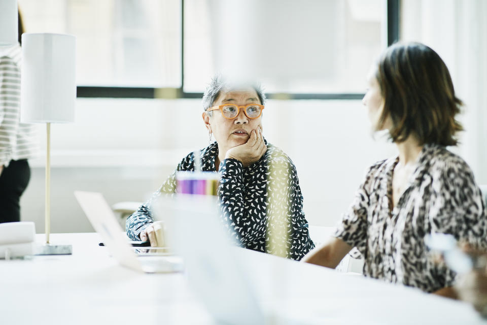 Businesswomen in discussion while working in coworking office