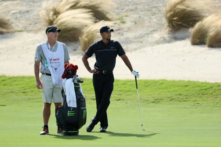 Tiger Woods, playing alongside fellow American Patrick Reed in windy conditions, sent his first shot into the left rough, ending his longest career layoff after 466 days