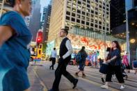 FILE PHOTO: People cross a street the Central business district in Hong Kong