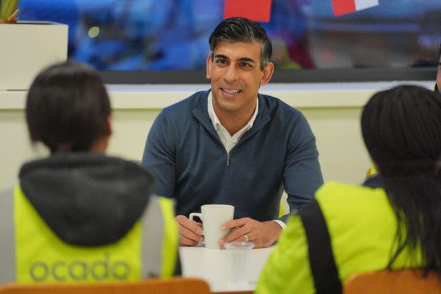 Rishi Sunak talks to people in hi-vis jackets