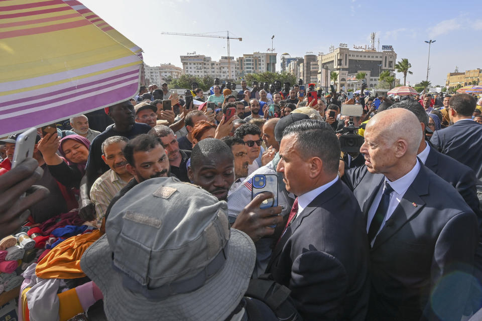 This photo provided by the Tunisian Presidential Palace Sunday June 11, 2023 shows Tunisian President Kais Saied , right, meeting residents during a surprise visit to Sfax, Saturday, June 10, 2023. Tunisia is hosting the leaders of Italy, the Netherlands and the European Union on Sunday for talks aimed at smoothing the way for an international bailout and restoring stability to a country that has become a major source of migration to Europe. (Slim Abid/ Tunisian Presidential Palace via AP)