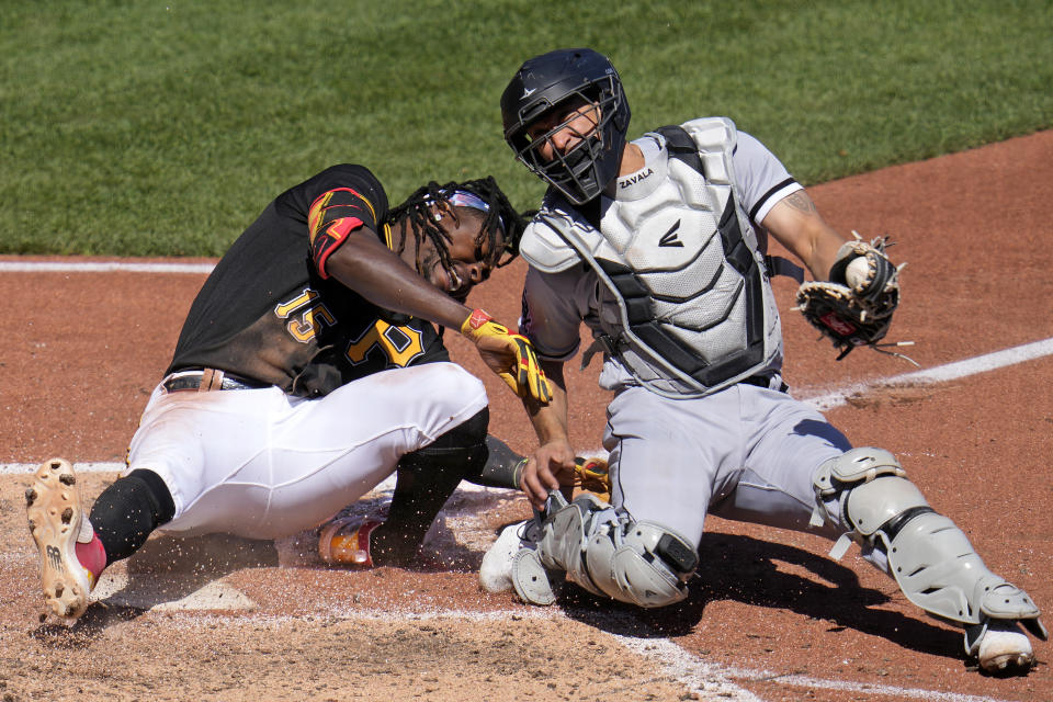 Pittsburgh Pirates' Oneil Cruz (15) is injured as he is tagged out attempting to score by Chicago White Sox catcher Seby Zavala during the sixth inning of a baseball game in Pittsburgh, Sunday, April 9, 2023. A bench clearing brawl ensued as a result of the play. The Pirates won 1-0. (AP Photo/Gene J. Puskar)