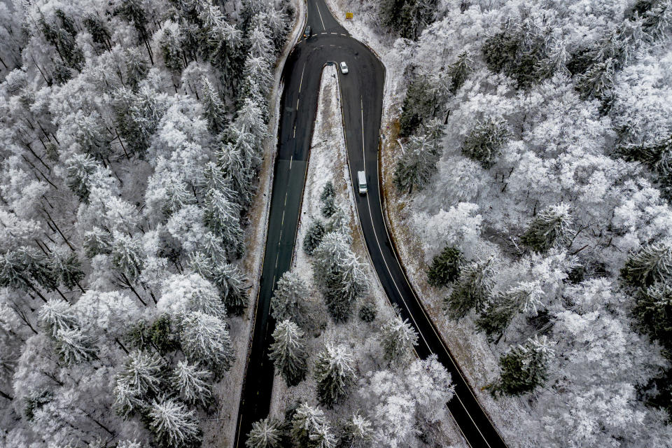 Cars drive up to the snow covered top of the Feldberg mountain near Frankfurt, Germany, Jan. 14, 2024. (AP Photo/Michael Probst, File)