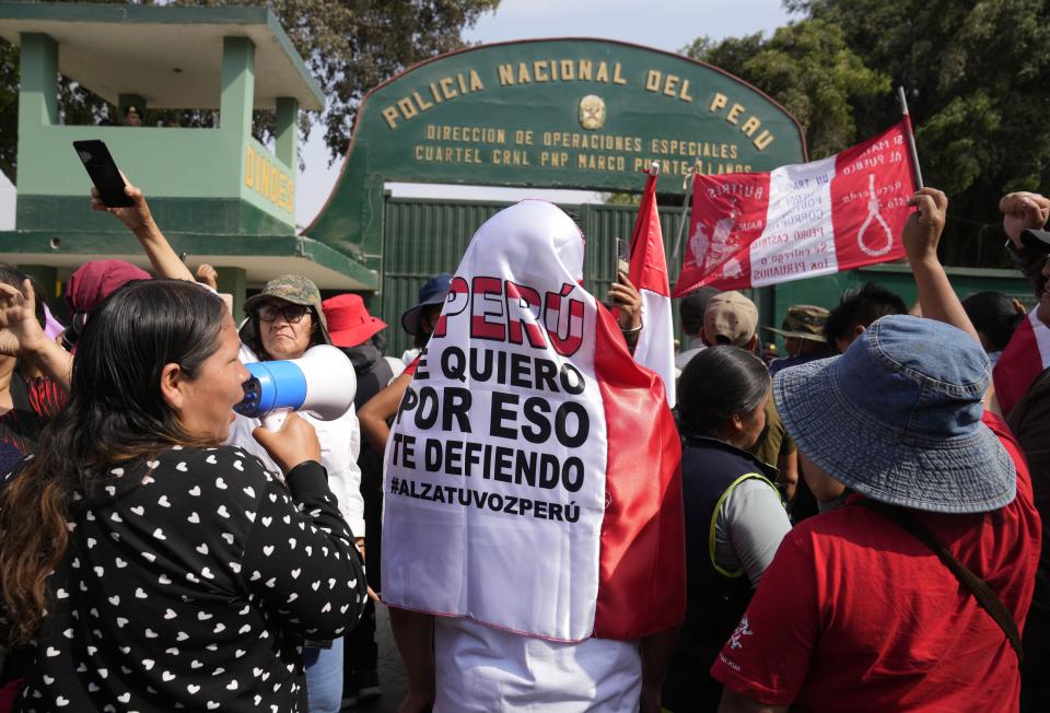 Supporters of ousted President Pedro Castillo gather outside the police base where he is being held following his arrest and faces charges of rebellion on the outskirts of Lima, Peru, Wednesday, Dec. 14, 2022. Peru's new government declared a 30-day national emergency on Wednesday amid violent protests following Castillo's ouster, suspending the rights of "personal security and freedom" across the Andean nation. (AP Photo/Martin Mejia)