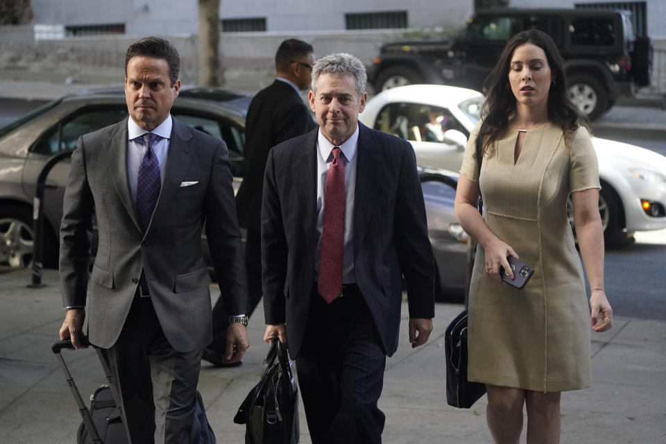 Attorneys Alan Jackson, left, Mark Werksman, center, and Jacqueline Sparagna, representing Harvey Weinstein, arrive at the Los Angeles County Superior Court Monday, Oct. 24, 2022, in Los Angeles. A jury of nine men and three women has been selected in the Los Angeles rape and sexual assault trial of Harvey Weinstein, and opening statements are set to start Monday. (AP Photo/Marcio Jose Sanchez)