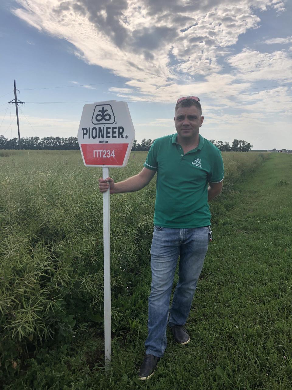 Russian farmer Roman Zimin poses with a Pioneer seed sign in an undated promotional photo released by  Corteva AgriScience.