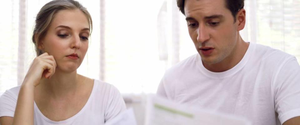 Young couple looking at their housing expenses.