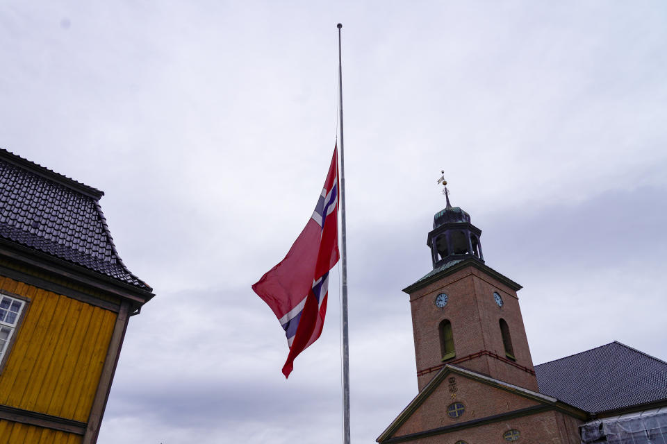 The Norwegian flag is at half-mast in Kongsberg the day after a man killed several people, in Kongsberg, Norway, Thursday, Oct. 14, 2021. Police in Norway are holding a 37-year-old man from Denmark suspected in a bow-and-arrow attack in a small town that killed five people and wounded two others. (Terje Bendiksby/NTB via AP)