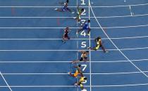 Usain Bolt over took Justin Gatlin in the final 50 metres to take out his third gold medal in the event. Photo: Getty