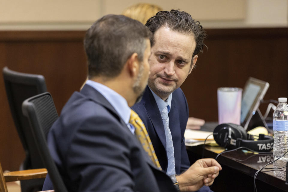 Defendant Charlie Adelson talks with his defense attorney Daniel Rashbaum before taking the stand to testify on his own behalf, Thursday, Nov. 2, 2023, in Tallahassee, Fla. Adelson is charged with first-degree murder, conspiracy and solicitation in the killing of Dan Markel, a 41-year-old attorney and legal scholar at Florida State University. (Alicia Devine/Tallahassee Democrat via AP, Pool)