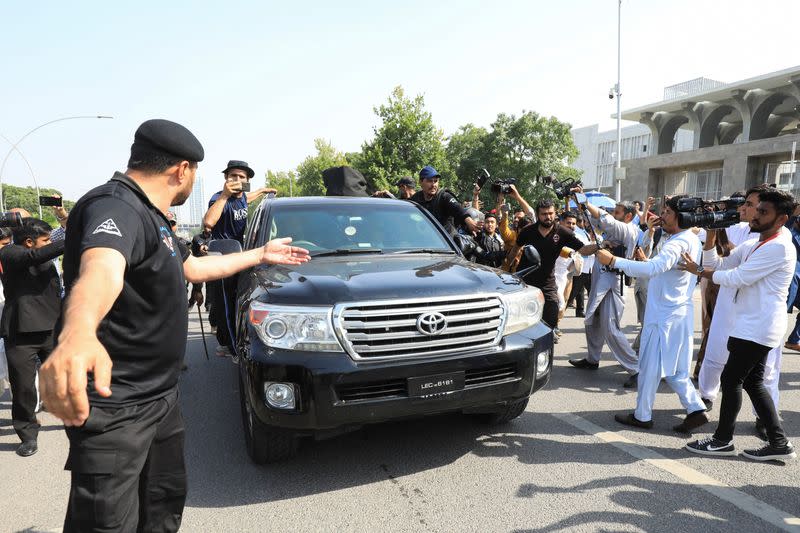 Vehicle carrying Pakistan's former Prime Minister Imran Khan drives outside the High Court in Islamabad