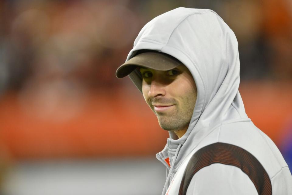 Cleveland Browns quarterback Baker Mayfield smiles with a hoodie pulled over his head
