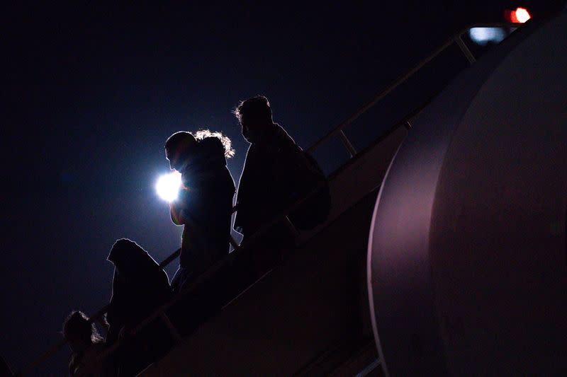 British nationals and Afghan evacuees depart a flight from Afghanistan at RAF Brize Norton