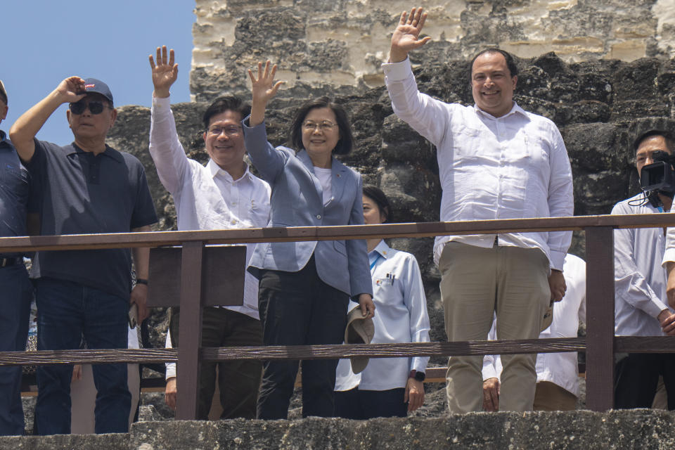 Taiwan's President Tsai Ing-wen, center left, and Guatemala's Foreign Minister Mario Bucaro, wave from top of "Templo de las mascaras" or the temple of masks, during a visit to the Mayan site Tikal, in Peten, Guatemala, Saturday, April 1, 2023. Tsai is in Guatemala for an official three-day visit. (AP Photo/Moises Castillo)