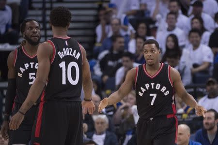 December 28, 2016; Oakland, CA, USA; Toronto Raptors guard Kyle Lowry (7) is congratulated by guard DeMar DeRozan (10) during the third quarter against the Golden State Warriors at Oracle Arena. The Warriors defeated the Raptors 121-111. Mandatory Credit: Kyle Terada-USA TODAY Sports