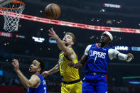 Indiana Pacers forward Domantas Sabonis (11) fights for a rebound between Los Angeles Clippers guards Reggie Jackson (1) and Amir Coffey (7) during the first half of an NBA basketball game in Los Angeles, Monday, Jan. 17, 2022. (AP Photo/Ringo H.W. Chiu)