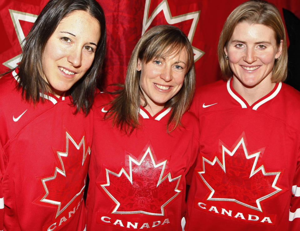 FILE - Canadian women's hockey team co-captain Jayna Hefford, center, is flanked by co-captain Carolina Ouellette, left, and captain Hayley Wickenheiser, right, in Calgary, Alberta, Dec. 21, 2009. The newly established Professional Women’s Hockey League has scheduled a news conference for Tuesday, Aug. 29, 2023, to make its long-awaited announcement on where its six franchises will be based. Hefford is slated to become senior vice president of hockey operations. (AP Photo/The Canadian Press, Jeff McIntosh, File)