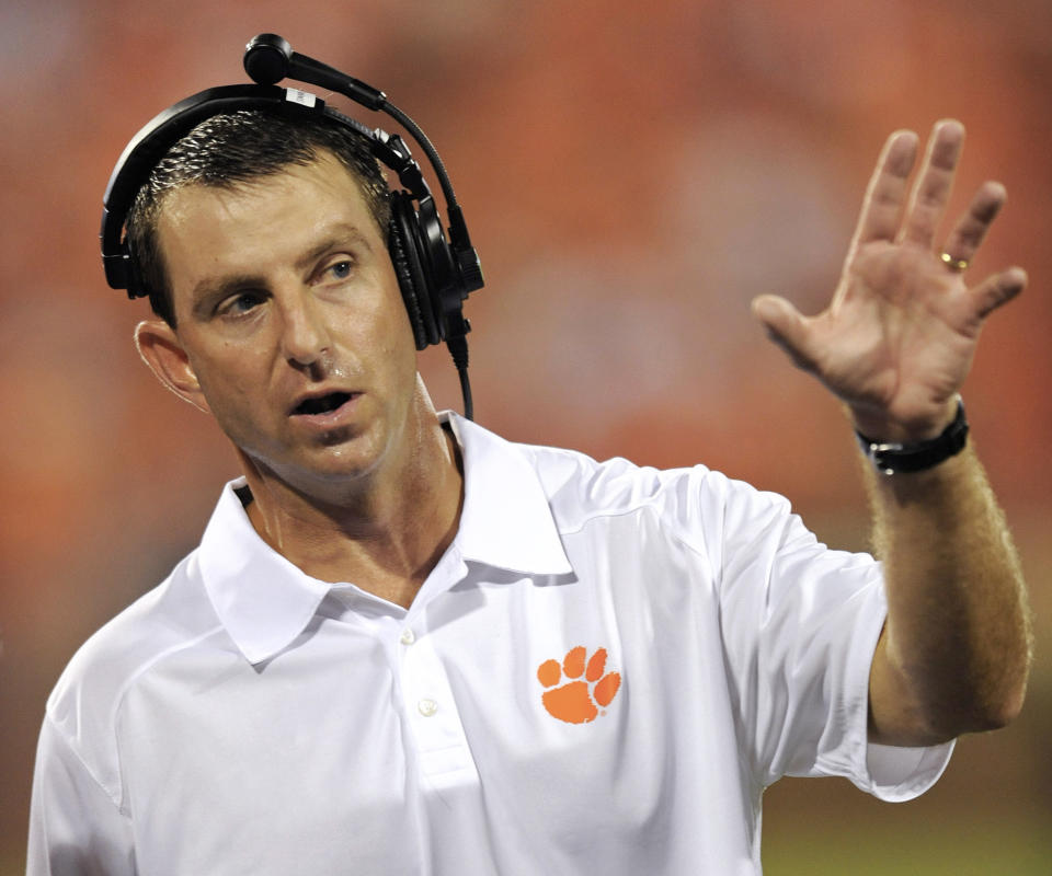 FILE - In this Aug. 31, 2013, file photo, Clemson coach Dabo Swinney reacts to a play during the second half of an NCAA college football game against Georgia at Memorial Stadium in Clemson, S.C. Swinney received a new, eight-year contract and a raise that increased his total pay for next season to $3.15 million. (AP Photo/ Richard Shiro, File)