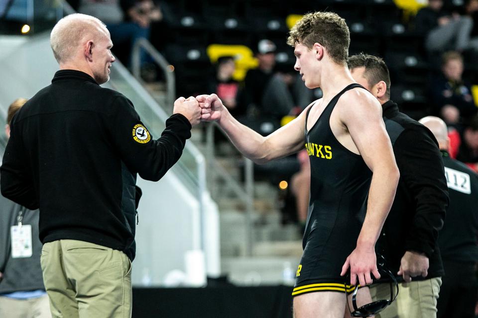 Waverly-Shell Rock's Aiden Riggins celebrates with coaches after winning his match at 160 pounds during the finals of the Dan Gable Donnybrook on Saturday.