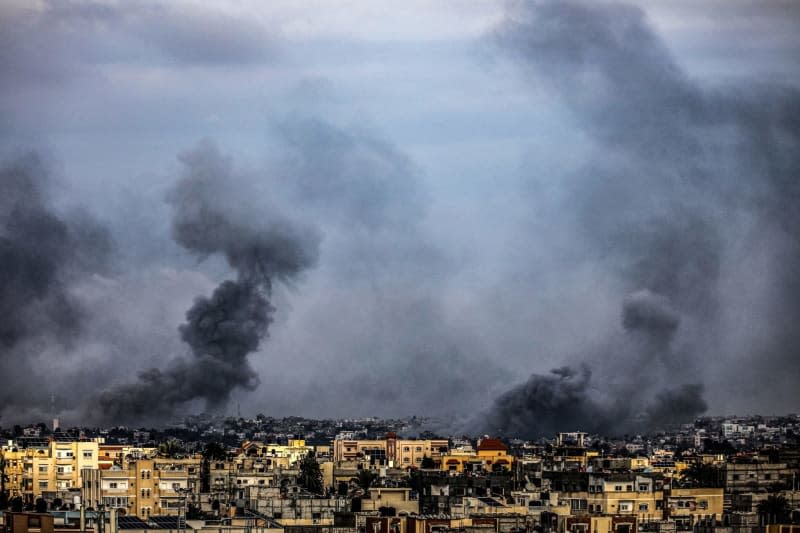 Smoke rises over buildings following an Israeli air strike. Abed Rahim Khatib/dpa