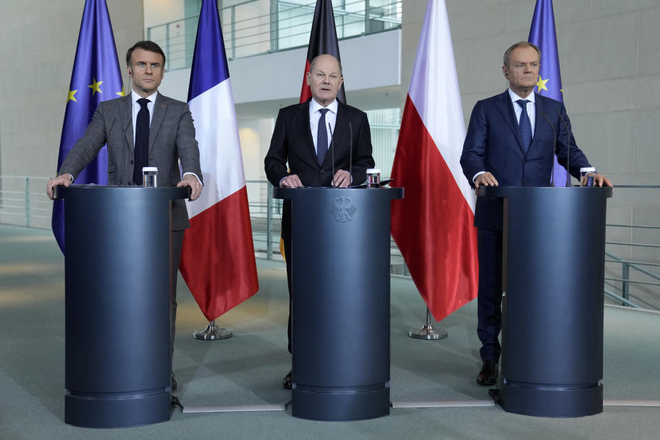 German Chancellor Olaf Scholz, center, French President Emmanuel Macron, left, and Poland's Prime Minister Donald Tusk talk to the media in Berlin, Germany, Friday, March 15, 2024. German Chancellor Olaf Scholz, France's President Emmanuel Macron and Poland's Prime Minister Donald Tusk meet in Berlin for the so-called Weimar Triangle talks. (AP Photo/Ebrahim Noroozi)