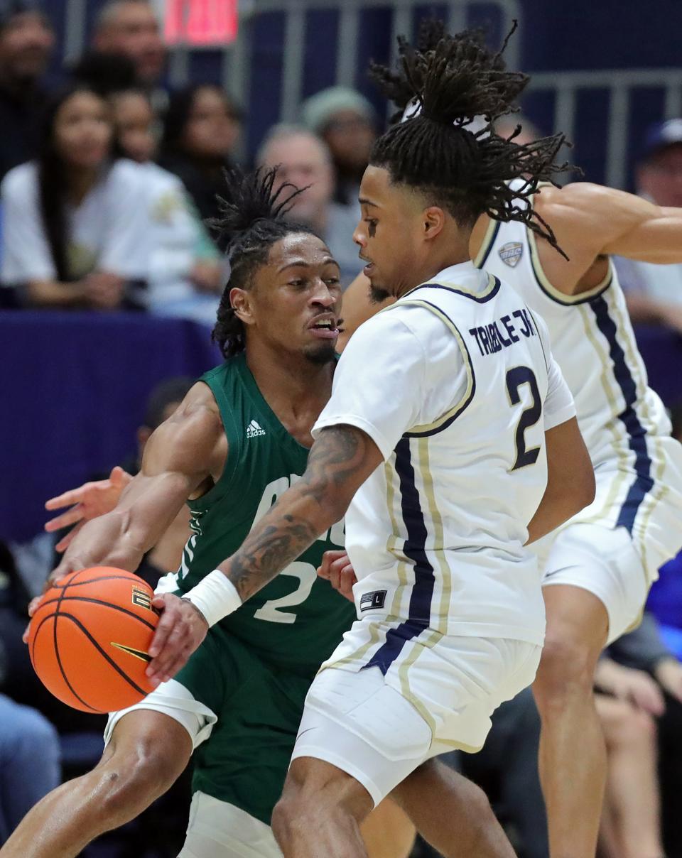 Ohio Bobcats guard Miles Brown has the ball knocked away by Akron Zips guard Greg Tribble during the first half, Tuesday, Jan. 23, 2024.