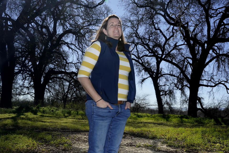 Julie Rentner, president of the nonprofit River Partners, stands by a small grove of trees during a tour of the Dos Rios Ranch Preserve in Modesto, Calif., Wednesday, Feb. 16, 2022. River Partners is restoring 2,100 acres of former farmland into a wildlife habitat and restore floodplain. (AP Photo/Rich Pedroncelli)