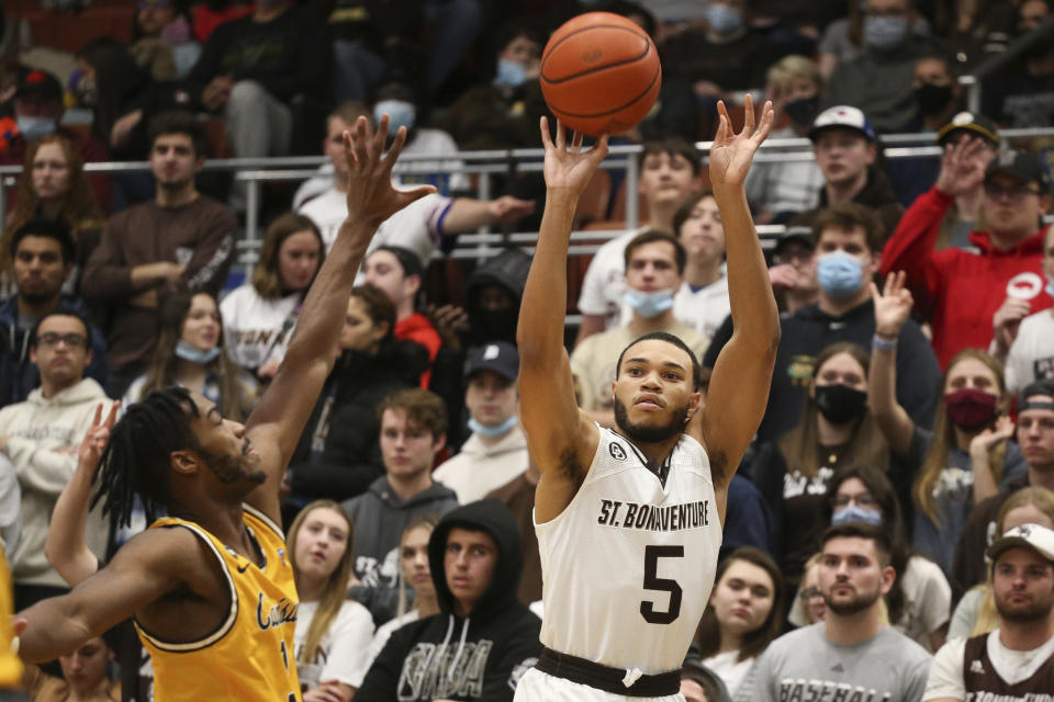 St. Bonaventure guard Jaren Holmes (5) shoots a 3-pointer while defended by Canisius guard Jordan Henderson (3) during the first half of an NCAA college basketball game, Sunday, Nov. 14, 2021, in Olean N.Y. (AP Photo/Joshua Bessex)