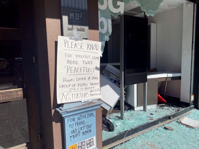 Business store windows are seen smashed along 2nd Avenue after protests the night before, during nationwide unrest following the death in Minneapolis police custody of George Floyd, in the East Village neighbourhood of Manhattan