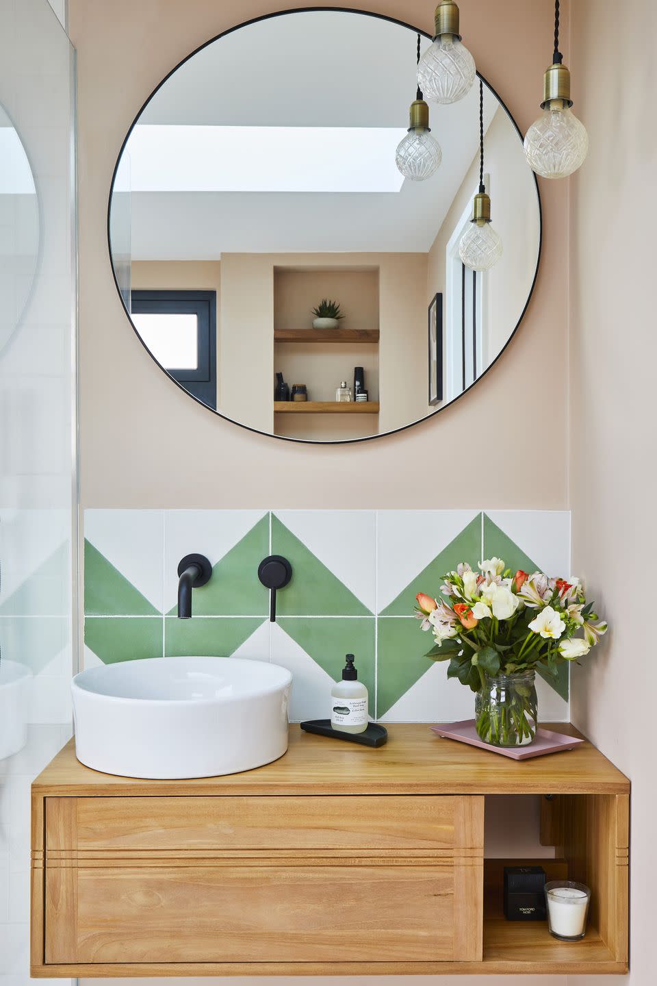 corner of a bathroom with sink and mirror