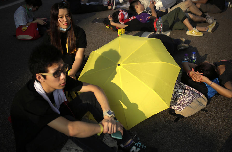 Student activists sleep on a road near the government headquarters where pro-democracy activists have gathered and made camp, Tuesday, Sept. 30, 2014, in Hong Kong. (AP Photo/Wong Maye-E)