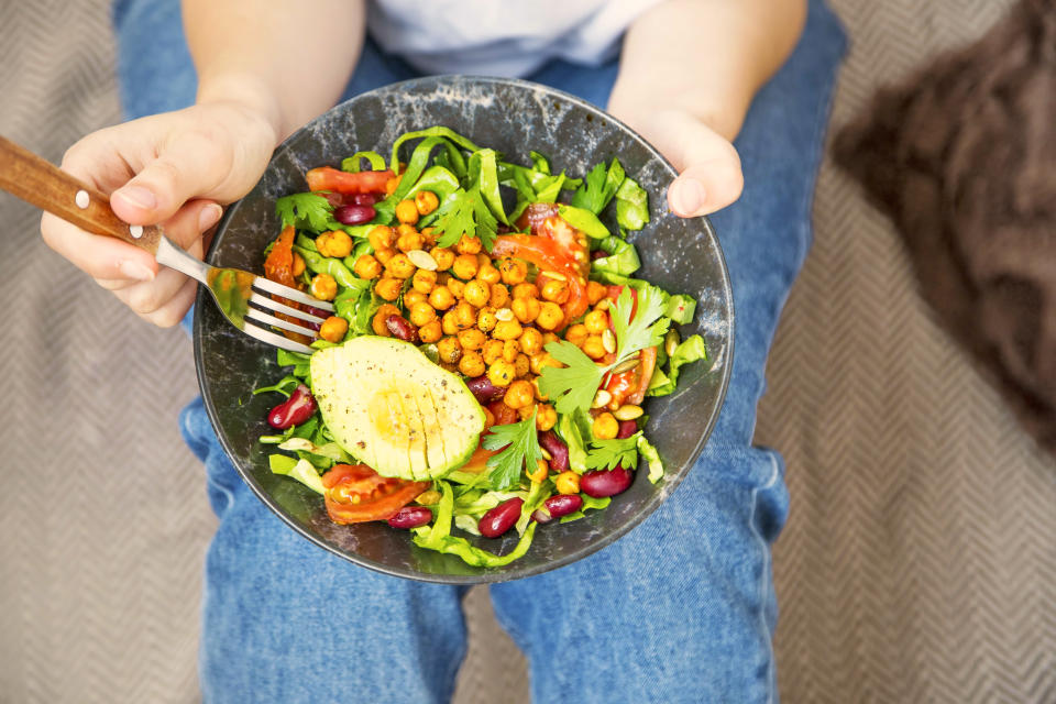 lean eating, vegan healthy salad bowl , top view of woman holding salad bowl, plant based healthy diet with greens, salad, chickpeas and vegetables