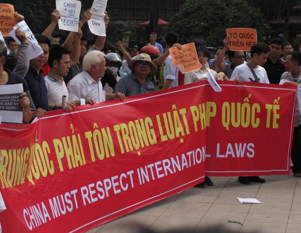 Vietnamese protesters stage a rally against Beijing's deployment of an oil rig in the contested waters of the South China Sea, outside the Chinese Embassy on Sunday, May 11, 2014 in Hanoi, Vietnam. The deployment of the rig has a triggered a tense standoff in the ocean and raised fears of confrontation between the neighboring countries. (AP Photo/Chris Brummitt)