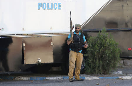 An armed man stands inside the Erebuni police station seized by "Sasna Tsrer" movement members in Yerevan, Armenia, July 23, 2016. REUTERS/Vahram Baghdasaryan/Photolure