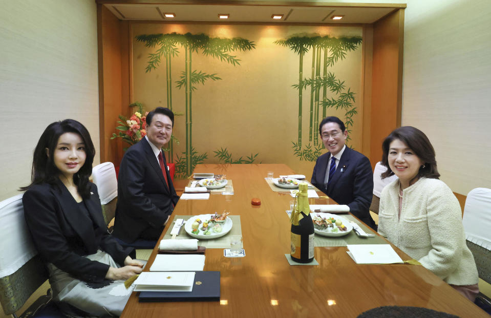 In this photo provided by Public Relations for the Cabinet Office, South Korean President Yoon Suk Yeol, second left, his wife Kim Keon Hee, left, Japanese Prime Minister Fumio Kishida, second right, and his wife Yuko Kishida pose for a photo at a Japanese restaurant in Tokyo, Thursday, March 16, 2023. (Public Relations for the Cabinet Office via AP)