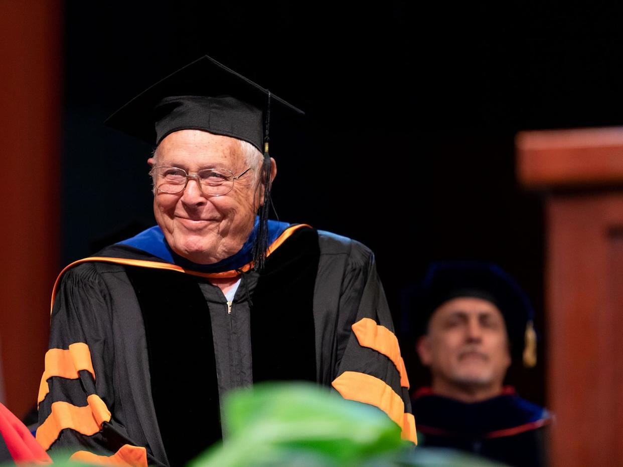 Lew Griffith finally walks the stage to accept his college diploma, after missing his opportunity three times 