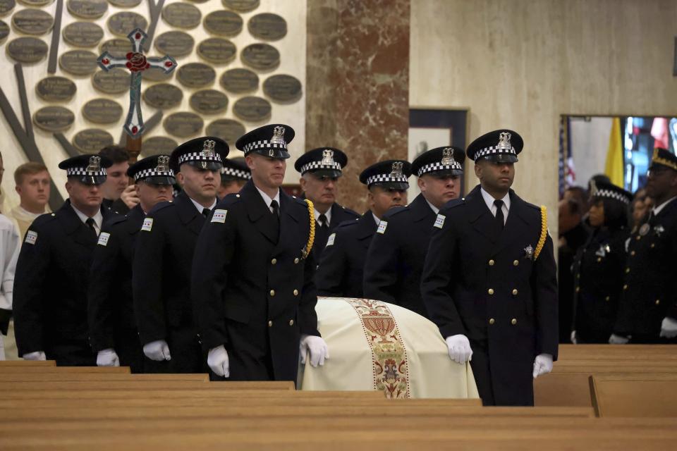 Chicago police officers carry in the body of Officer Andres Vasquez-Lasso on Thursday, March 9, 2023, prior to his funeral Mass at St. Rita of Cascia Shrine Chapel in Chicago. Vasquez-Lasso was shot and killed as he responded to reports of a man chasing a woman with a gun in Gage Park. (Stacey Wescott/Chicago Tribune via AP, Pool)