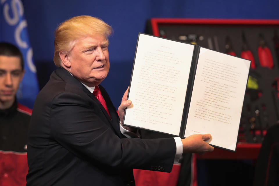 KENOSHA, WI - APRIL 18:  President Donald Trump signs an executive order to try to bring jobs back to American workers and revamp the H-1B visa guest worker program during a visit to the headquarters of tool manufacturer Snap-On on April 18, 2017 in Kenosha, Wisconsin.  (Photo by Scott Olson/Getty Images)