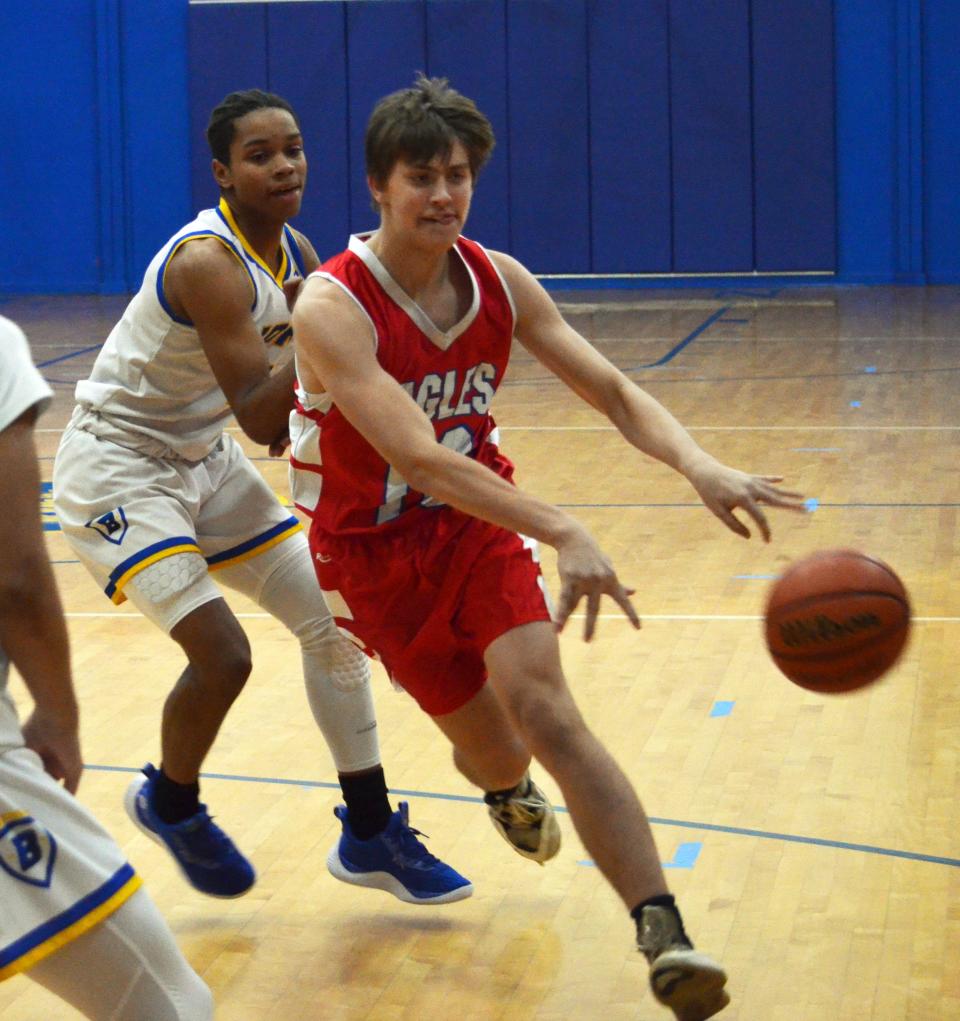 Heritage's Noah Poe dishes off a pass against Broadfording. He had six assists in the Eagles' 63-43 win.