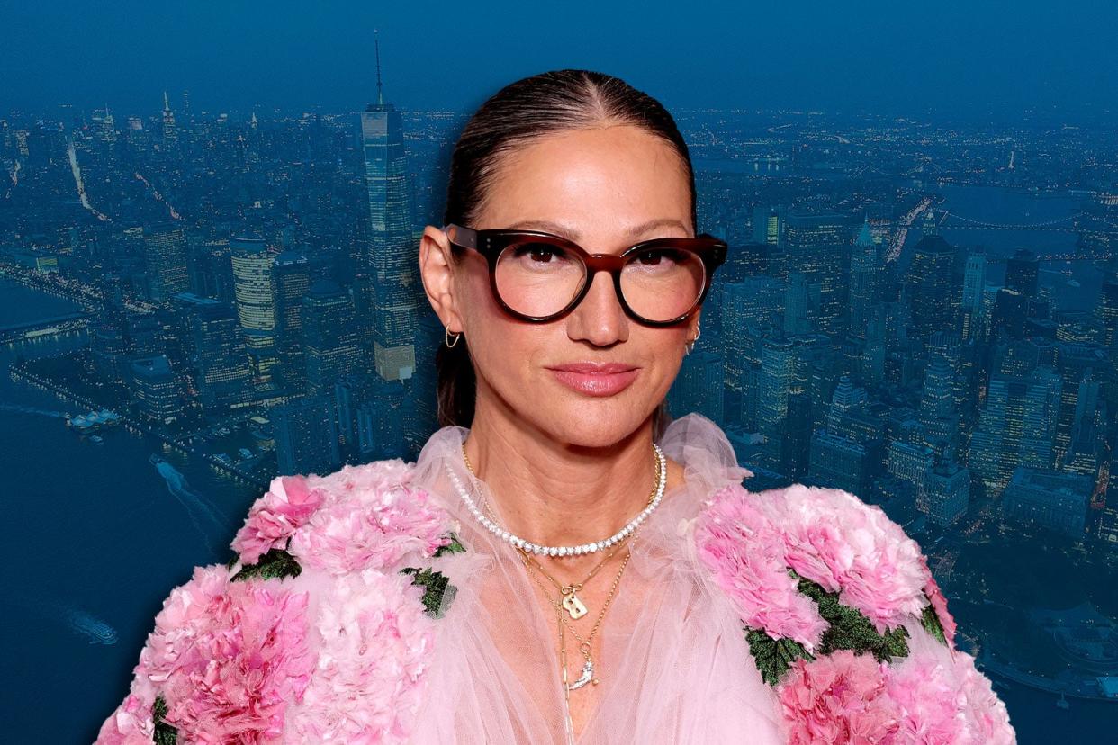 Jenna Lyons wearing glasses and pink, set against a backdrop of New York.