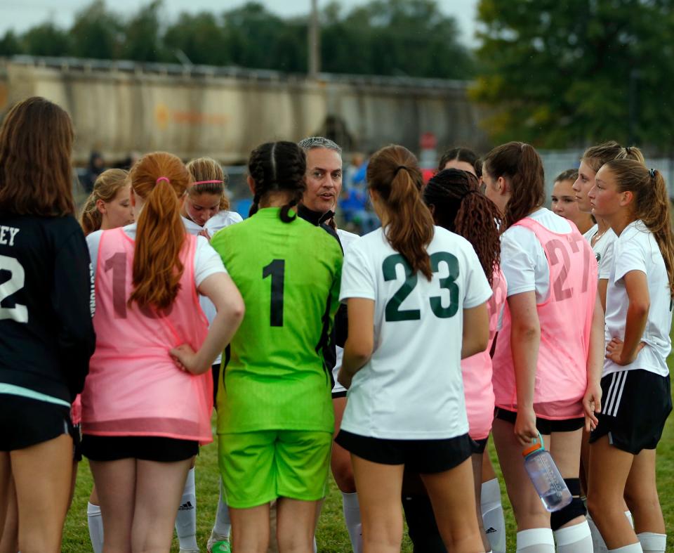 South Bend Trinity at Greenlawn girls soccer head coach Ryan Milligan, center, talks to his team at halftime of a game against Bethany Christian Tuesday, Sept. 19, 2023, at Bethany Christian High School in Goshen.