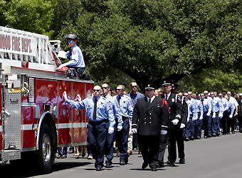 Brownwood firefighters escort the casket of Shannon Stone after Stone's funeral service on July 11