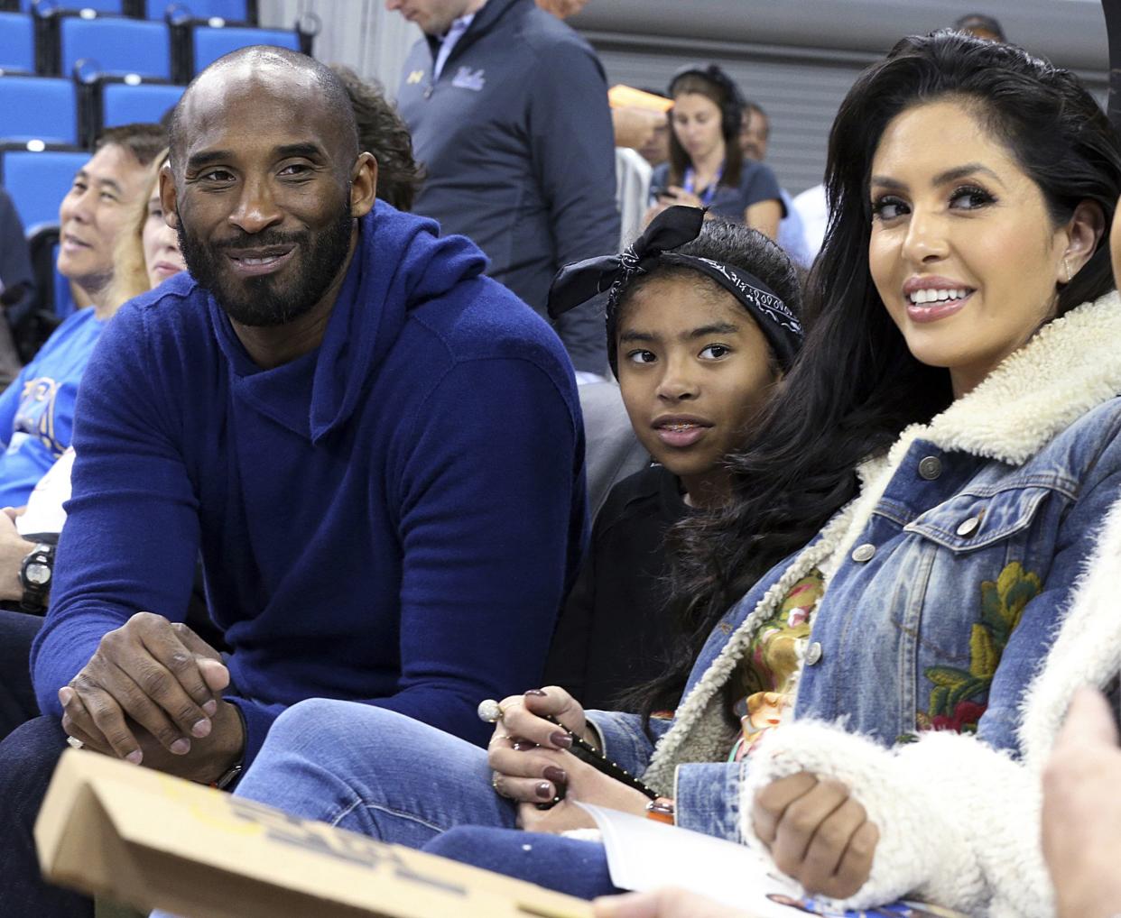 In this Nov. 21, 2017, file photo, from left, Los Angeles Lakers legend Kobe Bryant, his daughter Gianna Maria-Onore Bryant, wife Vanessa are seen before an NCAA college women's basketball game between Connecticut and UCLA, in Los Angeles.